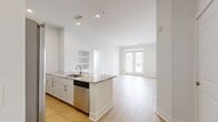 This 950-square-foot, two-bedroom, two-bathroom apartment at 580 S Goddard Blvd in King of Prussia, PA offers a clean, modern living environment across a single floor. Light-toned luxury vinyl plank flooring flows throughout, complementing the crisp white walls and bright, open atmosphere.

The kitchen features white shaker-style cabinetry with brushed gold hardware, granite countertops, stainless steel appliances including a refrigerator, dishwasher, and range, and seamlessly connects to the living area. The combined kitchen and living room provides a versatile, open-concept layout.

The primary bedroom spans 150 square feet and is accompanied by an en-suite bathroom finished with marble-look porcelain tile flooring, a double-sink vanity with granite countertops, white cabinetry, gold-toned fixtures, and a glass-enclosed shower. The second bedroom features large windows offering exterior views and benefits from a well-appointed full bathroom with a tub-shower combo, subway tile surround, and matching granite vanity.

Both bedrooms are served by dedicated closets, including a spacious walk-in closet with wire shelving systems. An in-unit laundry room houses a full-size washer and dryer. A hallway connects all rooms efficiently, completing this well-organized and contemporary apartment.