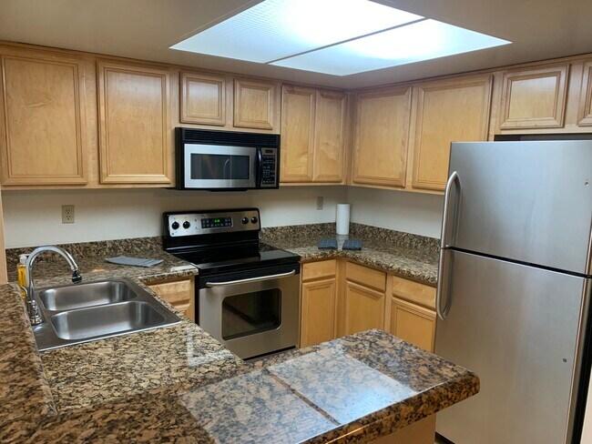 Furnished, ground floor, 2-bedroom condo with assigned covered parking.Pool,Spa,Tennis, Gym. - 5757 W Eugie Ave
