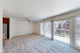 Located at 725 College Ave in Santa Rosa, CA, this single-floor, 2-bedroom, 1-bathroom residence offers a functional and comfortable layout. The combined living and dining area is a welcoming centerpiece of the home, featuring plush carpeting, a ceiling fan, and large sliding glass doors that open to a private balcony with lush tree views, filling the space with abundant natural light. The hallway, finished with warm hardwood-style flooring, connects the main living area to the bedrooms and bathroom, providing a clean transition between spaces. The kitchen is well-appointed with rich wood cabinetry, stone-look countertops, a peninsula for additional prep space, black appliances including a gas range, built-in microwave, and dishwasher, plus track lighting and a window overlooking the outdoors. Both bedrooms are carpeted and feature closets, with one bedroom offering sliding glass door access to the balcony. The second bedroom includes a sliding closet and connects easily to the shared hallway. The bathroom is finished with hardwood-style flooring and includes a vanity with wood cabinetry. With five closets throughout and a dedicated laundry area, this residence provides generous storage and practical everyday convenience.