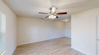 Located at 4636 Canterbury Dr in Myrtle Beach, SC, this single-floor home offers a clean, functional layout with consistent finishes throughout. The living areas feature light hardwood-style flooring that lends a bright, airy feel to the space, complemented by crisp white walls and ceiling fans with integrated lighting in every room. Natural light filters in through windows fitted with horizontal blinds, enhancing the open atmosphere.

The kitchen is well-equipped and thoughtfully designed, featuring warm taupe cabinetry with modern hardware, white countertops, a stainless steel sink, and a full suite of black appliances including an electric range, over-the-range microwave, dishwasher, and refrigerator. The layout allows for efficient workflow and connects conveniently to the main living area.

The bedrooms are carpeted for comfort, each featuring a ceiling fan and ample closet space with double-door or louvered closet doors. The rooms maintain the same neutral palette found throughout the home, offering a versatile canvas for any décor style.

The bathroom includes a tub-shower combination, a toilet, and a vanity with a single-basin sink set in dark wood cabinetry, finished with wood-look tile flooring. The overall design of this home is practical and move-in ready, with cohesive finishes that create a welcoming environment throughout.