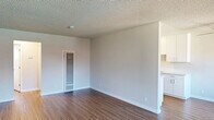 Located at 2376 Fairfield Ave in Fairfield, California, this single-story, one-bedroom, one-bathroom unit offers a well-organized layout across a comfortable footprint. The open living room is bright and airy, featuring warm hardwood-style flooring, a textured ceiling, a wall-mounted mini-split system for climate control, and sliding glass doors that lead to a private balcony with outdoor views — filling the space with abundant natural light.

The galley-style kitchen is efficiently designed with white cabinetry, light quartz countertops, a stainless steel gas range, microwave, refrigerator, and a single-basin sink, making excellent use of its streamlined layout.

The generously sized primary bedroom features dual mirrored sliding closet doors, hardwood-style flooring, a textured ceiling, and a window that welcomes natural light. A connecting hallway links the bedroom to the rest of the unit, providing a natural sense of flow throughout.

The bathroom is clean and bright, appointed with a white vanity, quartz countertop, a full tub-shower combo with white tile surround, and a window for natural ventilation. Throughout the unit, neutral tones and consistent flooring create a cohesive, inviting ambiance ideal for comfortable everyday living.