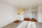 Located at 1025 Wakerobin Ln in Fort Collins, Colorado, this single-floor, 3-bedroom, 2-bathroom home offers a practical and comfortable layout. The open living area greets you at the entry, featuring a mix of rich hardwood-style flooring and plush carpet, with abundant natural light streaming through large windows fitted with vertical blinds. A ceiling fan adds comfort to the living space.

The kitchen is positioned adjacent to the living area, separated by a half-wall peninsula that creates an open pass-through feel. White cabinetry, white appliances including a range and refrigerator, and overhead lighting give the kitchen a clean, functional character. A dedicated laundry area adds everyday convenience.

The primary bedroom is a well-proportioned retreat with soft carpet, multiple windows, and a ceiling fan. Two additional bedrooms share a similar bright aesthetic, each featuring carpeted floors, vertical-blind windows that invite natural light, and easy access to closet storage. Three closets are distributed throughout the home.

Both bathrooms are finished with warm hardwood-style flooring, white vanity cabinetry, large mirrors with bar lighting, and clean white fixtures. One bathroom includes a shower-tub combination. A central hallway connects the bedrooms and bathrooms, keeping the layout efficient and functional throughout.