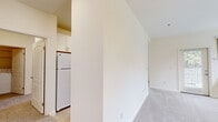 Located at Amador Village Circle in Hayward, California, this one-bedroom, one-bathroom residence offers a thoughtfully organized single-level layout across a comfortable footprint. The space includes two living areas, providing flexibility for both lounging and dining or workspace needs. Large windows in the living room flood the area with natural light and offer pleasant views of surrounding greenery, while a glass door leads directly to an outdoor area, enhancing the connection to the exterior. Soft carpeting runs throughout the living and bedroom areas, contributing to a warm, quiet ambiance.

The galley-style kitchen is efficiently designed with white shaker cabinetry, dark granite-look countertops, tile flooring, white appliances including a refrigerator, electric range, and microwave, and a view through to a secondary living area — making the space feel open and connected. The generously sized primary bedroom features a large window with a tree-lined view, carpeted floors, and access to a hallway with a closet.

The full bathroom is well-appointed with white cabinetry, dark countertops, a wide vanity mirror, and a shower-tub combination. A dedicated in-unit laundry area with side-by-side washer and dryer and overhead shelving adds everyday convenience to this functional Hayward residence.