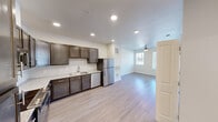 Located at 4500 Nuckols Crossing Rd in Austin, TX, this single-story, one-bedroom, one-bathroom unit offers an efficient and well-designed layout across a compact footprint. Light wood-style flooring runs continuously throughout, lending a clean, cohesive look to the entire space.

The kitchen is a standout feature, equipped with dark espresso cabinetry, light granite-style countertops, a subway tile backsplash, and a full suite of stainless steel appliances including a refrigerator, dishwasher, microwave, and range. Recessed lighting illuminates the kitchen and extends into the open living area, which benefits from natural light through windows fitted with horizontal blinds and is finished with a ceiling fan overhead.

An in-unit washer and dryer are conveniently housed within the main living space, adding practical value. The bedroom is a well-proportioned room featuring a ceiling fan, a natural light window, and light-toned walls with matching flooring. A dedicated closet provides organized storage.

The bathroom is clean and functional, featuring a granite-topped vanity with dark cabinetry, tile-surround tub/shower combo, and coordinating light flooring. Overall, the unit presents a modern, move-in-ready aesthetic with consistent finishes throughout.