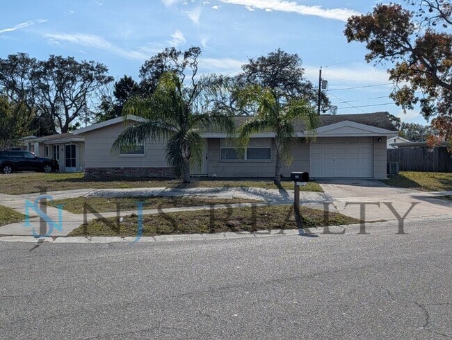 Building Photo - This 3/2/1 with over 1100 sq ft offers all tile floors open kitchen/dining, split floor plan on a...