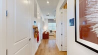 Located at 2507 Koji St in Mount Dora, Florida, this single-story, 2-bedroom, 3-bathroom home offers a thoughtfully designed open-concept layout finished with light hardwood flooring throughout. The kitchen is a standout feature, showcasing crisp white shaker cabinetry extending to the ceiling, gleaming quartz countertops, a subway tile backsplash, stainless steel appliances, and a spacious island with bar seating — ideal for both cooking and casual dining. The kitchen flows seamlessly into the living room, which is brightened by natural light from large windows and features a ceiling fan and generous wall space. The primary bedroom is a comfortable retreat with a ceiling fan, natural light from a well-positioned window, and a dedicated en-suite bathroom. The primary bath includes a dual-sink vanity with white cabinetry, quartz countertops, a glass-enclosed walk-in shower, and access to a closet. The second bedroom is equally well-appointed with natural light and warm finishes. All three bathrooms maintain a clean, modern aesthetic consistent with the rest of the home. A dedicated laundry area adds everyday convenience. The private outdoor space features a white vinyl privacy fence, gravel ground cover, and a Florida-blue sky backdrop, offering a low-maintenance retreat perfect for the local climate.