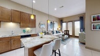 Located at 2001 S Voss Rd in Houston's Westheimer/Voss corridor, this well-appointed one-bedroom, one-bathroom residence offers a thoughtfully designed open-concept layout across a single floor. Large-format porcelain tile flows through the main living areas, reflecting natural light and enhancing the sense of space.

The kitchen is a standout feature, showcasing rich warm-toned cabinetry extending to the ceiling with a built-in wine rack, stainless steel appliances, granite countertops, and a central island with bar seating — ideal for casual dining or entertaining. Pendant lighting adds a warm, inviting glow to the space.

The living room is bright and airy, with French doors opening to a private balcony offering city views. The space accommodates comfortable seating and is anchored by large-scale artwork and elegant drapery.

The bedroom offers a cozy retreat with plush carpet, generous natural light through wide windows with city views, and access to a dedicated closet. The bathroom is finished with a dark granite vanity, warm wood cabinetry, a frameless glass walk-in shower with tile surround, and polished chrome fixtures — delivering a clean, modern aesthetic throughout.