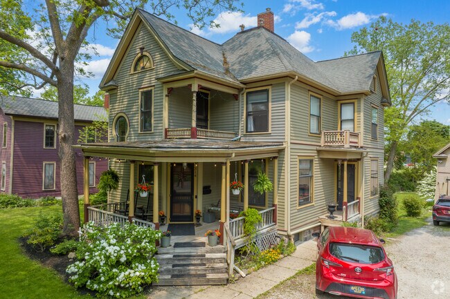 Transitional Queen Anne style Colonial Revival with classic detailing in Saline.
