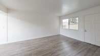 Located at 7337 Power Inn Rd in Sacramento, CA, this single-floor residence offers three bedrooms and one bathroom within a thoughtfully laid-out floor plan. The interior features a clean, modern aesthetic with crisp white walls and bright finishes throughout. The living areas are finished with durable wood-look flooring that lends warmth and continuity across the main spaces, while vertical blinds on the windows allow for adjustable natural light. A second living area connects seamlessly, enhancing the sense of openness. The kitchen is well-appointed with gray shaker-style cabinetry, light quartz-style countertops, and white appliances including a refrigerator, electric range, and dishwasher, complemented by wood-look tile flooring and a skylight overhead. The three bedrooms feature plush carpeting and white walls, with the primary bedroom offering a comfortable, well-proportioned layout and a window with outdoor views. The full bathroom is outfitted with a vanity featuring quartz-style counters, gray cabinetry, a tub-shower combination, and wood-look flooring, maintaining the home's cohesive modern style. A hallway connects the private areas of the home efficiently. Overall, the unit presents a clean, move-in-ready environment with consistent finishes throughout.