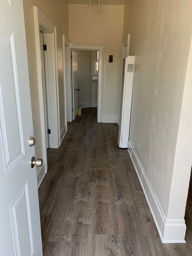 Front entrance looking down hallway to bathroom - 128 Lewelling Blvd