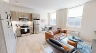 Located in Pittsburgh's South Side neighborhood, this one-bedroom, one-bathroom residence at 2024 Jane St offers a thoughtfully designed open-concept layout with modern finishes throughout. Light hardwood flooring flows seamlessly across the entire unit, creating a cohesive and airy aesthetic.

The kitchen is a standout feature, outfitted with light wood cabinetry extending to the ceiling for ample storage, white countertops, and a full suite of stainless steel appliances including a range, microwave, dishwasher, and refrigerator. The kitchen opens directly into the dining and living areas, making the space ideal for everyday living and casual entertaining.

The living room benefits from a large window that draws in natural light and features clean white walls, recessed lighting, and an efficient, comfortable layout. The bedroom is a well-proportioned retreat with a window for natural light, light-toned hardwood floors, and neutral walls that create a calm atmosphere.

The bathroom is finished with a sleek sliding glass walk-in shower, wood-toned vanity with modern black hardware, recessed lighting, and wood-look flooring that ties together the unit's contemporary design language. This unit delivers a clean, modern living experience in a compact and efficient floor plan.