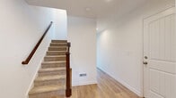 Located at 376 Avon Dr in Red Lion, PA, this newly constructed three-story home offers a well-organized layout across three distinct levels. The entry-level garage provides convenient enclosed parking and storage. The main living floor serves as the heart of the home, featuring an open-concept kitchen and living area highlighted by white shaker cabinetry, granite countertops, a central island, stainless steel appliances, elegant pendant lighting, and light hardwood-style flooring — all bathed in natural light from surrounding windows. The upper floor hosts four bedrooms, including a generously sized primary suite, along with three full bathrooms. Bedrooms feature light hardwood or plush carpet flooring, walk-in closets, and clean white walls that create a bright, airy feel. Bathrooms are finished with clean white surrounds and modern fixtures. Throughout the home, white panel doors and neutral tones lend a fresh, move-in-ready aesthetic. The rear of the property opens to sweeping views of rolling Pennsylvania farmland and open fields under wide skies, offering a serene rural backdrop that can be enjoyed from the outdoor deck.