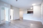 Located at 4712 Flat Shoals Rd in Union City, Georgia, this single-floor residence offers a well-designed, open layout with a clean, modern aesthetic throughout. The main living area is bright and spacious, featuring warm wood-look flooring, neutral wall tones, and flush-mount ceiling lighting that creates an inviting atmosphere. A peninsula counter seamlessly connects the living area to the kitchen, enhancing the open-concept flow.

The kitchen is thoughtfully appointed with rich, dark espresso cabinetry, granite-style countertops, and black appliances including a refrigerator, range, built-in microwave, and dishwasher. Ample counter space lines both sides of the galley-style layout, providing excellent functionality for everyday use.

The bedroom is a comfortable retreat, highlighted by a ceiling fan, a window with outdoor views of surrounding greenery, and a reach-in closet with built-in shelving. The wood-look flooring continues throughout, maintaining a cohesive design.

The bathroom features neutral tile flooring, a full-size soaking tub with shower combination, a toilet, and a dark-cabinetry vanity with a white countertop and integrated sink. Clean lines and a muted color palette give the bathroom a tidy, practical finish. Overall, this residence presents a well-maintained, move-in ready space with consistent modern finishes from room to room.