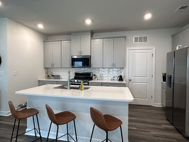 Spacious and modern kitchen. Oversized cabinets and a gas range - 4111 Honey Locust Dr