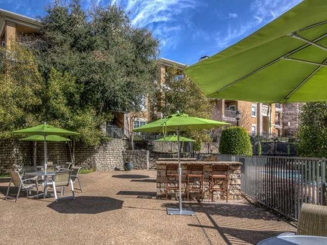 Outdoor grills with seating and umbrellas - The Pavilions