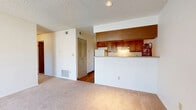 Located at 4941 W 81st Place in Westminster, Colorado, this two-bedroom, one-bathroom residence offers a well-organized single-floor layout designed for comfortable everyday living. The open living room is finished with neutral wall-to-wall carpeting and features a sliding glass door that floods the space with natural light and provides direct access to an outdoor balcony. A textured ceiling runs throughout the main living areas, adding a classic architectural touch.

The galley-style kitchen is efficiently arranged with warm wood cabinetry lining both sides, light-toned countertops, a double stainless steel sink, an electric range, and a full-size refrigerator. A pass-through peninsula separates the kitchen from the living area, creating an open connection between the two spaces. Hardwood-style flooring runs through the kitchen, adding warmth and easy maintenance. A louvered closet door provides convenient pantry or utility storage within the kitchen.

Both bedrooms are carpeted and bathed in natural light through windows fitted with blinds. Each room includes closet storage, and the primary bedroom offers a comfortable, well-proportioned layout. The full bathroom features wood-look flooring, a tiled tub-and-shower combination, and a wood-toned vanity. Additional storage is provided by four closets and a dedicated utility room throughout the home.