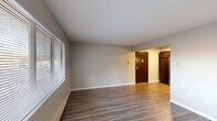 This well-appointed 2-bedroom, 1-bathroom residence in Toledo, Ohio offers a thoughtfully designed single-floor layout. The kitchen is a standout feature, showcasing rich dark-espresso cabinetry that extends to the ceiling for generous storage, granite-look countertops, a double-basin sink, and a full suite of stainless steel appliances including a refrigerator, gas range, built-in microwave, and dishwasher. Durable hardwood-style flooring runs throughout the kitchen and living areas, lending a clean, modern aesthetic. The spacious living room benefits from natural light through large windows fitted with blinds and features a wall-mounted air conditioning unit and baseboard heating. Both bedrooms are carpeted for comfort, each with natural light from exterior windows and access to closet space — with an impressive five closets distributed throughout the unit for exceptional storage. The primary bedroom is generously sized, offering ample room for furnishings. A dedicated laundry area adds everyday convenience. Neutral wall tones throughout create a bright, move-in-ready atmosphere. The overall layout is efficient and functional, making excellent use of the available space.