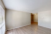 Located at 710 S College Rd in Lafayette, Louisiana, this single-floor residence offers 2 bedrooms and 3 bathrooms within a thoughtfully laid-out floor plan. The living room greets you with light-toned wood-look flooring, neutral walls, a textured ceiling, and a large window that invites natural light and outdoor views. A distinctive built-in shelving unit connects the living area to the rest of the home, adding both character and functional storage. The galley-style kitchen features white cabinetry, granite-look countertops, and an electric range, with a pass-through view to the built-in shelving beyond. The bedrooms are carpeted for comfort; the primary bedroom is generously sized and includes a ceiling fan with light fixture, a window with natural light, and a sliding-door closet with a full-length hanging rod. The bathrooms are consistently finished with white vanity cabinetry, granite-look countertops, large mirrors with overhead lighting, and white medicine cabinets. A connecting hallway ties all rooms together efficiently. The overall aesthetic is clean, neutral, and functional, making the space highly adaptable for a variety of living arrangements.