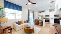 Located at 3784 Bryce Ln in Kissimmee, FL, this well-appointed single-story home offers 2 bedrooms and 3 bathrooms across a thoughtfully designed floor plan. Light wood-tone flooring flows throughout, complemented by recessed lighting and a clean, neutral color palette.

A welcoming hallway with multiple closets leads into the bright, open-concept living, dining, and kitchen area. The living room features a ceiling fan, large windows dressed in bold blue Roman shades and drapes, and ample natural light. The kitchen is well-equipped with white shaker cabinetry extending to the ceiling, stainless steel appliances, quartz countertops, a center island with bar seating, and pendant lighting — ideal for both everyday cooking and entertaining.

The primary bedroom offers a comfortable retreat with wood-tone flooring, soft neutral walls, and access to an en-suite bathroom featuring a glass-enclosed walk-in shower, a white vanity with quartz countertops, and a dedicated walk-in closet. The second bedroom is equally well-sized and bright.

Three full bathrooms provide convenience for residents and guests. A dedicated laundry area adds further practicality. The private patio features artificial turf, a paved area, and tropical landscaping, offering an inviting outdoor living space under the Florida sun.
