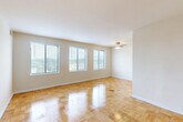 Located at 5309 Riverdale Rd in Riverdale Park, MD, this one-bedroom, one-bathroom residence offers a thoughtfully organized single-floor layout with a bright, clean aesthetic throughout. Warm parquet wood flooring flows consistently across all living areas, lending a classic and cohesive character to the space.

The combined living and dining area is the heart of the home, featuring multiple large windows that flood the room with natural light and offer pleasant views of the surrounding greenery. A ceiling fan adds both function and a finishing touch to this open, airy space.

The kitchen is efficiently designed and equipped with standard appliances, including a gas range and sink, positioned to make the most of the available space. Adjacent areas connect seamlessly via a hallway that provides access to the bedroom and bathroom.

The bedroom is a comfortable, well-proportioned retreat with its own window framing outdoor views and parquet flooring that continues from the main living areas. Notable storage is a highlight of this residence, with four closets total — including a large double-door closet in the bedroom.

The bathroom is clean and functional, featuring white tile surrounding a full soaking tub, a vanity with sink, and a toilet. The overall ambiance of the space is light, neutral, and move-in ready.