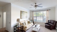 Located at 50 St Andrews Dr in Augusta, Georgia, this well-designed single-floor residence offers two bedrooms, two bathrooms, a dedicated office, and a comfortable blend of functional and inviting living spaces. The bright living room features crown molding, a ceiling fan, soft carpet, and large windows that frame views of lush greenery, filling the space with natural light. Adjacent to the living area, the dining room showcases elegant wainscoting, a pendant light fixture, and a tiled accent wall, creating a refined atmosphere for entertaining. The kitchen is equipped with white cabinetry, dark countertops, a breakfast bar peninsula, and track lighting, opening seamlessly to the dining area. The spacious primary bedroom includes a ceiling fan and large windows dressed with blinds and curtains. The second bedroom is similarly comfortable and well-lit. The dedicated office features a built-in desk, open shelving, and generous natural light from multiple windows, making it ideal for remote work or study. The bathrooms include a soaking tub with tiled surround. A dedicated laundry room with side-by-side washer and dryer connections adds everyday convenience. Two closets provide ample storage throughout the home.