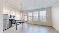 Located at 1295 Chesapeake Ave in Columbus, Ohio, this 1-bedroom, 1-bathroom residence offers a thoughtfully designed single-floor layout with modern finishes throughout. The open-concept living and kitchen area is anchored by light hardwood-style flooring, soaring ceilings, and track lighting paired with pendant fixtures that create a bright, welcoming ambiance. The kitchen is a functional highlight, featuring white upper cabinetry, contrasting dark lower cabinets, subway tile backsplash, light quartz countertops, and a full suite of stainless steel appliances including a refrigerator, range, and over-the-range microwave. Natural light flows generously through large windows fitted with blinds. The bedroom is a comfortable retreat finished with plush carpet flooring and dual windows that allow ample daylight and neighborhood views. A dedicated closet provides practical storage. The bathroom is elegantly finished with marble-style tile flooring, a matching marble-surround walk-in shower, a wood-toned vanity with white countertop, and clean white walls that contribute to a crisp, upscale feel. The space also includes a dedicated closet, completing this efficient and stylish residence.