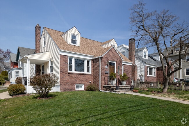 A Cape Cod-style home in Bergenfield, NJ has a side porch.