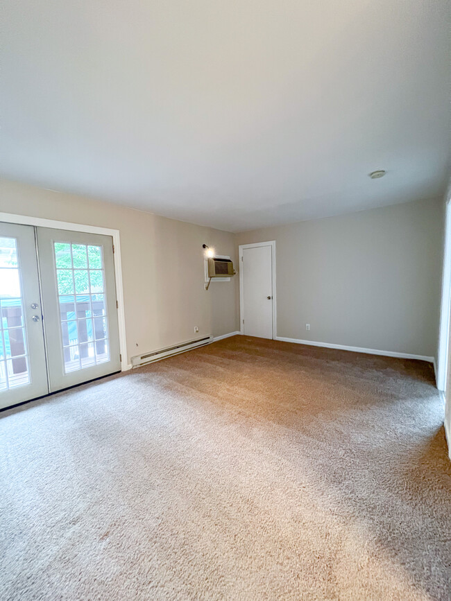 Living room with large french doors that leads to private balcony - 100 Myrtle Ave