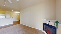 Located at 4910 N Monroe Street in Tallahassee, Florida, this well-appointed one-bedroom, one-bathroom unit offers a comfortable and functional layout across a single floor. The spacious living room immediately impresses with its vaulted ceiling, ceiling fan, and plush carpeting. A corner electric fireplace serves as a focal point, while a glass-paneled door opens to a private patio, allowing natural light to fill the room. The open-concept dining area and kitchen are finished with warm hardwood-style flooring and illuminated by a classic chandelier. The kitchen features white cabinetry, a center island with a breakfast bar, stainless steel appliances including a refrigerator, microwave, and range, as well as a dedicated pantry for additional storage. A hallway connects the main living areas to the private quarters, where the generously sized bedroom offers carpeted floors, a ceiling fan, and windows that invite natural light. The bedroom is complemented by a spacious walk-in closet with built-in wire shelving. The full bathroom includes a vanity with white cabinetry and a shower-tub combination. Additional highlights include a dedicated laundry room with utility shelving, multiple closets throughout, and a welcoming entrance — offering practical storage and everyday convenience.