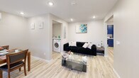 Located at 612 Hazard Ave in Enfield, Connecticut, this efficiently designed single-floor home offers three bedrooms, two full bathrooms, and a thoughtful layout that maximizes every square foot. Light-toned luxury vinyl plank flooring flows throughout the main living areas, creating a clean and cohesive aesthetic.

The living room is bright and open, featuring recessed lighting and a neutral palette that lends itself to a variety of design styles. Adjacent, the dining area accommodates a full-sized table and benefits from natural light through a window fitted with zebra-style roller blinds. The kitchen is a standout space, dressed in bold royal blue cabinetry with black hardware, white subway tile backsplash, white quartz countertops, and stainless steel appliances including a dishwasher — all illuminated by under-cabinet LED lighting.

Each bedroom is well-proportioned, with the primary bedroom featuring dual windows and ample natural light. All bedrooms include wall-mounted mini-split units for individualized climate control. The two bathrooms are finished with striking marble-style tile walls, wood-look tile flooring, and black fixtures, one featuring a soaking tub/shower combination. A dedicated laundry room with a full-size washer and dryer adds everyday convenience to this move-in-ready home.