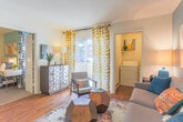 Located at 70 Lakeshore Drive in Hampton, Virginia, this single-floor residence offers a well-organized and cheerfully designed layout. The open living area is anchored by warm hardwood flooring and features a large sliding glass door that invites abundant natural light and outdoor views. A vibrant teal accent wall complements eclectic décor, creating an inviting and lively ambiance throughout.

The kitchen is functionally appointed with warm wood cabinetry, dark countertops, and a full suite of stainless steel appliances, including a refrigerator, range, and built-in microwave. The space flows naturally into the main living and dining areas, making it well-suited for both everyday use and entertaining.

The bedroom continues the home's colorful design aesthetic, with a teal accent wall, plush carpeting, and bold patterned curtains that add personality and warmth to the space.

The full bathroom features hardwood flooring, a wide double-sink vanity with ample storage cabinetry, a large mirror, and a shower-tub combination.

A dedicated in-unit laundry area provides added convenience with a full-size washer and dryer alongside a water heater. Throughout the residence, thoughtful design choices and a cohesive color palette contribute to a bright, welcoming atmosphere.