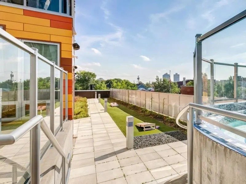 Rooftop pool and lounge area with cityscape view