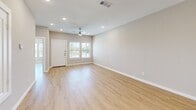 Located at 9004 Apple Orchard Ln in Fort Worth, Texas, this two-story home offers four bedrooms and three bathrooms across two well-proportioned floors. The main floor serves as the heart of the home, housing the combined kitchen and living area, a garage, and a bathroom. The living room is bright and welcoming, featuring light wood-look flooring, recessed lighting, a ceiling fan, and windows that bring in natural light. The kitchen is a standout feature, showcasing white shaker-style cabinetry, gleaming quartz countertops, a large peninsula with an undermount sink, and stainless steel appliances including a range, microwave, and refrigerator. The upper floor hosts the remaining bedrooms and bathrooms, connected by a hallway and staircase. The primary bedroom offers a comfortable footprint with ample natural light from dual windows. Bedrooms throughout feature the same light wood flooring and neutral wall tones. The bathrooms are finished with white vanity cabinetry, quartz countertops, and wood-look flooring; one full bath includes a tub-shower combo. A dedicated closet and an attached two-car garage with an automatic opener round out this well-appointed home with a clean, modern aesthetic.