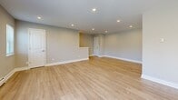Located in Lancaster, PA, this thoughtfully designed 2-bedroom, 2-bathroom residence offers a clean, modern aesthetic throughout its single-floor layout. The spacious living room serves as the heart of the home, featuring light-toned hardwood-style flooring, recessed lighting, and large windows that fill the space with abundant natural light and offer pleasant outdoor views. The open feel is further enhanced by neutral-toned walls and clean white trim throughout.

Both bedrooms are generously sized, finished with soft plush carpeting, ceiling fans with light fixtures, and ample closet space. The primary bedroom includes a sizable built-in closet and multiple windows. Each bedroom has direct access to a well-appointed bathroom, providing a convenient and functional layout.

The two bathrooms showcase contemporary finishes, including large-format neutral tile work. One bathroom features a sleek walk-in shower with a glass enclosure and chrome fixtures, while the second offers a full soaking tub with an overhead rain shower, complemented by a white vanity with a marble-style countertop.

A connecting hallway and dedicated closet space add to the home's practical design. The overall ambiance is bright, clean, and modern — a move-in-ready residence that balances comfort and style in a desirable Lancaster location.