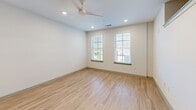 Located at 577 Meeting St in Charleston's vibrant 29403 zip code, this single-floor unit offers a thoughtfully designed layout that maximizes function and style. Light-toned hardwood flooring runs throughout, complementing the clean white walls and creating a bright, cohesive aesthetic.

The open-concept kitchen and living area serves as the heart of the unit. The kitchen is outfitted with warm wood-grain cabinetry, light granite countertops, stainless steel appliances including a range, microwave, and refrigerator, and a central island with a sink and pendant lighting overhead — providing both prep space and a natural gathering point. Recessed lighting and a ceiling fan keep the living area comfortable and well-lit, while multiple windows dressed with horizontal blinds invite natural light and views of the surrounding neighborhood.

The bathroom features a full tub-shower combination with marble-look tile surround, wood-toned flooring, a granite-topped vanity, and chrome fixtures, offering a clean and polished finish. The dedicated closet is equipped with wire shelving systems that provide organized, multi-level storage.

Throughout the unit, thoughtful details — from crown molding accents to recessed lighting — reflect a modern yet comfortable design sensibility well-suited to Charleston's dynamic urban setting.