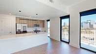 This sleek 1190 square foot apartment in Atlanta offers a perfect blend of style and functionality. The open-concept design seamlessly integrates the living room and kitchen, creating an expansive space ideal for both relaxation and entertainment. The gourmet kitchen boasts modern light wood cabinetry, stainless steel appliances, and a generous island with a built-in sink, perfect for culinary enthusiasts.

Floor-to-ceiling windows flood the living areas with natural light and provide breathtaking views of the Atlanta skyline. The primary bedroom, measuring 190 square feet, offers ample space and continues the apartment's contemporary aesthetic. Both bathrooms feature clean lines, with one showcasing a glass-enclosed shower and the other a modern bathtub-shower combination.

Throughout the apartment, light wood flooring adds warmth to the crisp white walls. Recessed lighting and modern ceiling fans enhance the overall ambiance. The property includes two well-designed closets for storage. With its prime location at 10 Tower Rd NW in Atlanta, this apartment combines urban sophistication with comfortable living, making it an ideal home for those seeking a modern lifestyle in the heart of the city.