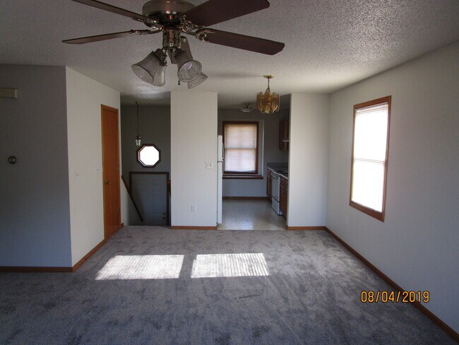 Living room with deck doors at your back - 2117 14th St Townhome