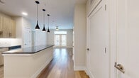 Located in Katy, TX, this well-appointed 2-bedroom, 2-bathroom residence offers a thoughtfully designed single-floor layout that maximizes comfort and functionality. Wide-plank wood-look flooring runs throughout, lending warmth and continuity to every room.

The open-concept kitchen and living area serves as the heart of the home. The kitchen features light wood cabinetry, a dark granite-topped island with seating potential, a white subway tile backsplash, and a trio of sleek black pendant lights that anchor the space with a modern touch. The living area flows seamlessly from the kitchen and is brightened by a ceiling fan and French doors that invite natural light and outdoor views.

The primary bedroom is a generously sized retreat with dual windows fitted with blinds and a ceiling fan for year-round comfort. It is complemented by a well-organized walk-in closet with multi-tiered shelving and hanging rods. The en-suite bathroom features a frameless glass walk-in shower, a warm wood vanity with dark granite countertops, and a large mirror. A second bedroom and full bathroom provide comfortable accommodations for guests or additional occupants. Two closets throughout the home offer ample storage. The clean, neutral color palette and consistent finishes create a cohesive and inviting ambiance throughout.