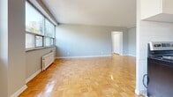Located at 137 Isabella Street in Toronto's vibrant Midtown neighbourhood, this one-bedroom, one-bathroom unit offers a well-organized layout across a single floor. Warm parquet flooring runs throughout the living, dining, and bedroom areas, lending a classic character to the space. The open living and dining area is generously proportioned, filled with natural light through large windows that frame views of the surrounding cityscape and greenery, complemented by a classic radiator heating system.

The galley-style kitchen features white cabinetry lining both walls, white tile backsplash, a stainless steel refrigerator, and a range, with light tile flooring and a window that brings in additional natural light. A dedicated entrance provides a practical transition into the home.

The bedroom is a comfortable size, offering a window with city views, radiator heating, parquet flooring, and a built-in closet for ample storage. The unit includes four closets in total, providing excellent storage throughout. The bathroom is finished with clean, white horizontal subway tile from floor to ceiling, a soaking tub with shower, a window for ventilation, and a white vanity. The overall palette of soft grey walls and bright white trim creates a calm, cohesive ambiance throughout.