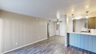 Located at 2600 Arroyo Ave in Dallas, TX, this efficiently designed 1-bedroom, 1-bathroom unit offers a thoughtful layout across a single floor. The living room is bright and open, featuring wood-look plank flooring, neutral-toned walls, and a ceiling fan with light fixture. A sliding glass door floods the space with natural light and provides access to a private outdoor patio, while a separate entry door adds convenience. The kitchen is stylishly updated with grey shaker-style cabinetry, quartz-look countertops, a hexagonal tile backsplash, stainless steel appliances including a range, microwave, and dishwasher, and a double-basin sink. A pendant light and pass-through counter connect the kitchen to the living area. In-unit washer and dryer connections are neatly tucked within the living space. The bedroom is a comfortable size, featuring a ceiling fan, a window with natural light, and direct access to a dedicated closet with built-in shelving. The bathroom includes a full tub-shower combo with white tile surround and brushed nickel fixtures. Wood-look flooring runs throughout, tying the space together with a cohesive, contemporary aesthetic.