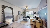 Located at 1401 Aschinger Blvd in Columbus, Ohio, this thoughtfully designed one-bedroom, one-bathroom residence offers a comfortable and functional single-floor layout. The open-concept living and kitchen area serves as the heart of the home, where light wood-tone flooring, crown molding, and a ceiling fan create an inviting atmosphere. Sliding glass doors lead to a private balcony, flooding the space with natural light and offering pleasant outdoor views. The kitchen is finished with dark cabinetry, granite countertops, a subway tile backsplash, and stainless steel appliances, combining style with practicality. A dedicated built-in workspace with matching dark cabinetry and granite surfaces provides a versatile area for productivity. The bedroom features plush carpeting, a bold botanical accent wall, and a walk-in closet, offering a serene and well-sized retreat. The bathroom includes a granite-topped dark vanity, a soaking tub with shower, and light wood-tone flooring that ties the space together. A combined bathroom and laundry area houses a full-size washer and dryer, adding everyday convenience. Throughout the residence, consistent finishes and a cohesive design palette contribute to a modern, comfortable living environment.