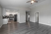 Located at 1533 W 11th St in Upland, California, this single-story home showcases a thoughtfully updated interior with a clean, neutral color palette and a seamless blend of comfort and functionality. The open-concept living area is anchored by light-toned luxury vinyl plank flooring that extends throughout the main living spaces, offering a cohesive and airy feel. Vaulted ceiling details in the living room add a sense of height and openness, while a ceiling fan provides added comfort. A wall-mounted mini-split system ensures efficient climate control in the living area. The kitchen is well-appointed with bright white shaker-style cabinetry, dark countertops, a stainless steel gas range, a stainless steel refrigerator, an under-mount sink, and recessed lighting — all combining to create a modern and highly functional cooking space. The bedrooms feature plush wall-to-wall carpeting, natural light from windows with blinds, and individual mini-split climate control units for personalized comfort. The bathroom is finished with wood-look tile flooring, a white vanity with dark countertop, a large mirror, and a tub-shower combination. Throughout the home, clean white trim and neutral wall tones create a welcoming, move-in-ready environment.