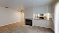 Located at 4001 S Watt in Sacramento, CA, this one-bedroom, one-bathroom unit offers a well-organized and functional layout across a single floor. The living room is a comfortable, carpeted space highlighted by a tile-surround fireplace and a ceiling fan, creating a cozy focal point for the room. A large sliding glass door with vertical blinds floods the area with natural light and provides easy access to the outdoors. The kitchen is thoughtfully designed in a galley style, featuring stainless steel appliances including a range, microwave, dishwasher, and refrigerator, complemented by granite countertops and crisp white cabinetry. Rich hardwood flooring runs throughout the kitchen and bathroom, adding warmth and contrast. The kitchen opens to the living area via a pass-through counter, enhancing the flow of the space. The bedroom is a peaceful retreat with plush carpet, a window with natural views, and direct access to a dedicated closet. The bathroom is well-appointed with a granite-top vanity, white cabinetry, and hardwood flooring. Clean neutral tones and consistent finishes throughout give the unit a cohesive and move-in-ready feel.