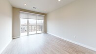 Located at 430 S Yellowstone Dr in Madison, WI, this well-appointed one-bedroom, one-bathroom unit offers a thoughtfully designed open-concept layout with clean, contemporary finishes throughout. The combined kitchen and living area serves as the heart of the home, anchored by a sleek peninsula with a white quartz countertop, an undermount sink, and stylish pendant lighting. Warm wood-toned cabinetry lines the galley-style kitchen, which is fully equipped with stainless steel appliances including a range, microwave, dishwasher, and refrigerator. Light hardwood-style flooring runs throughout the main living areas, enhancing the bright, airy ambiance. The living room opens directly onto a private balcony through full-height sliding glass doors, flooding the space with natural light and providing outdoor views. The bedroom is a comfortable retreat featuring plush carpet, a ceiling fan, and a window with a roller shade. A dedicated closet provides convenient storage. The bathroom maintains the same cohesive design language with wood-toned cabinetry, a white countertop vanity, and wood-look tile flooring. Recessed lighting and neutral wall tones tie the entire unit together in a clean, modern aesthetic.