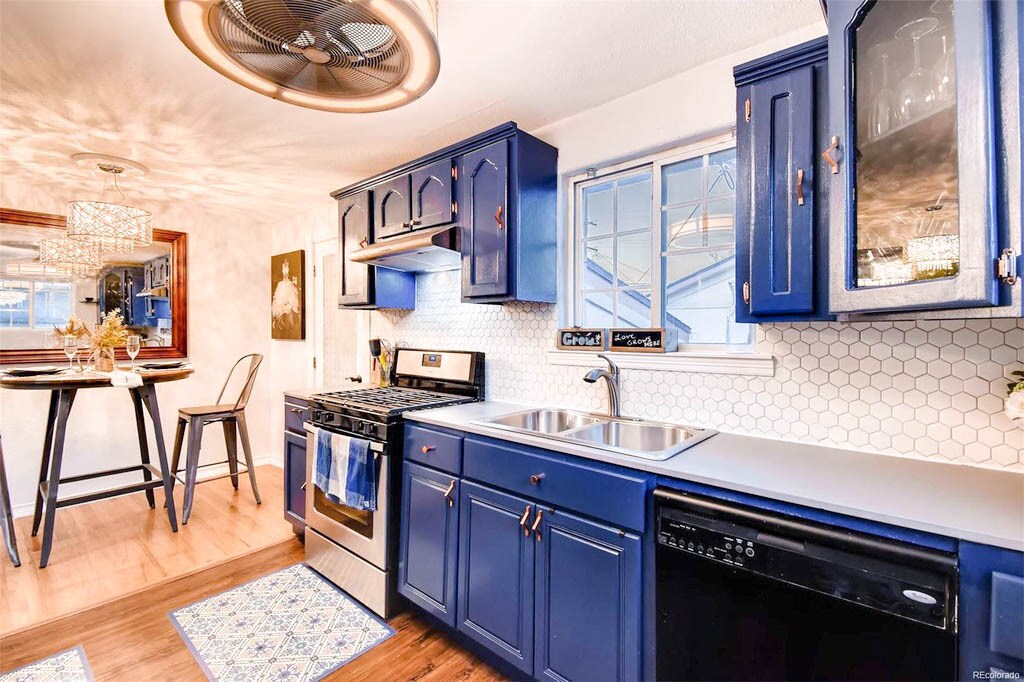 Adorable kitchen adds a pop of color with it’s charming cabinetry! - 4320 Quivas St