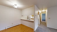 Located at 4628 Beech Ave in Kalamazoo, Michigan, this two-bedroom, one-bathroom unit offers a practical and well-organized single-floor layout. The living room is a comfortable, carpeted space highlighted by a sliding glass patio door that fills the room with natural light and provides access to the outdoors. A wall-mounted AC unit and baseboard heating ensure year-round comfort.

The kitchen features a galley-style design with warm oak cabinetry, ample counter space, tile flooring, and a full suite of appliances including a refrigerator and range. A pass-through counter connects the kitchen to the dining and living areas, creating an open feel between the spaces. Hardwood-style flooring in the entryway and dining area provides a clean contrast to the carpeted rooms.

Both bedrooms are carpeted and offer natural light through windows with blinds. The primary bedroom includes a double closet with wood-paneled doors, providing generous storage. The second bedroom also features closet storage and baseboard heating. The full bathroom includes a tub-shower combination with tiled accents, a wood-vanity with sink, and tile flooring. Throughout the unit, neutral wall tones and consistent wood-toned accents create a cohesive, functional living environment.