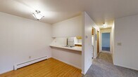 Located at 4628 Beech Ave in Kalamazoo, Michigan, this two-bedroom, one-bathroom unit offers a practical and well-organized single-floor layout. The living room is a comfortable, carpeted space highlighted by a sliding glass patio door that fills the room with natural light and provides access to the outdoors. A wall-mounted AC unit and baseboard heating ensure year-round comfort.

The kitchen features a galley-style design with warm oak cabinetry, ample counter space, tile flooring, and a full suite of appliances including a refrigerator and range. A pass-through counter connects the kitchen to the dining and living areas, creating an open feel between the spaces. Hardwood-style flooring in the entryway and dining area provides a clean contrast to the carpeted rooms.

Both bedrooms are carpeted and offer natural light through windows with blinds. The primary bedroom includes a double closet with wood-paneled doors, providing generous storage. The second bedroom also features closet storage and baseboard heating. The full bathroom includes a tub-shower combination with tiled accents, a wood-vanity with sink, and tile flooring. Throughout the unit, neutral wall tones and consistent wood-toned accents create a cohesive, functional living environment.