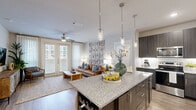 Located at 15915 Kingfield Dr in Houston, TX, this single-story, 3-bedroom, 2-bathroom home offers a well-designed open-concept layout that seamlessly connects the living, dining, and kitchen areas. Wood-look flooring runs throughout, lending warmth and continuity to the space.

The kitchen is a standout feature, boasting dark charcoal cabinetry with sleek hardware, granite countertops, stainless steel appliances, and a large central island with pendant lighting and bar seating — ideal for both cooking and entertaining. The living area is bright and inviting, with a ceiling fan, French doors that invite natural light, and direct access to the outdoors.

The primary bedroom is a comfortable retreat, featuring a ceiling fan, hardwood-style flooring, and a dedicated closet. The additional bedrooms offer similar finishes and natural light. Both bathrooms are appointed with dark cabinetry, granite vanity tops, and tiled tub-shower combinations.

The home also includes a dedicated laundry area and a closet for extra storage. Throughout the space, neutral tones and modern design choices create a clean, cohesive aesthetic. The layout is practical and efficient, making excellent use of the available footprint to deliver a comfortable and stylish living environment.