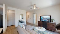 This thoughtfully designed 2-bedroom, 2-bathroom residence offers a single-level layout that maximizes both comfort and functionality. The open-concept living area features wood-style flooring, a ceiling fan, and a bright, neutral color palette that creates a clean and inviting atmosphere. The living space flows seamlessly into a well-appointed dining area, which benefits from abundant natural light courtesy of multiple windows dressed with sheer curtains and blinds.

The kitchen is a standout feature, showcasing dark espresso cabinetry, a grey subway tile backsplash, stainless steel appliances, and a large granite-topped island that serves as an ideal prep and gathering space. Pendant lighting adds a refined touch overhead.

Both bedrooms are generously proportioned and carpeted for comfort, each featuring ceiling fans, large windows with outdoor views, and ample closet space. The primary suite includes access to a walk-in closet with built-in shelving. The primary bathroom offers granite countertops and dark cabinetry, while the secondary bathroom features a full tub-shower combination with tile surround and matching granite vanity. Wood-style flooring runs consistently throughout the main areas, tying the space together with a cohesive, modern aesthetic.