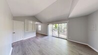 Located at 3270 Milstead in Toledo, OH, this 1-bedroom, 1-bathroom unit offers a well-organized single-floor layout encompassing a living room, dining room, kitchen, hallway, utility room, and three closets. The living room is a standout space, featuring dramatic vaulted ceilings and large sliding glass doors that open to a private outdoor deck, flooding the area with natural light and offering pleasant views of surrounding greenery. Light-toned, hardwood-style flooring runs throughout, complementing the neutral gray wall palette for a clean, cohesive aesthetic. A decorative lattice partition elegantly separates the living and dining areas while maintaining an open feel. The kitchen is equipped with gray cabinetry, gray countertops, a double stainless steel sink, and a range, providing a practical and stylish cooking space. The bedroom is a comfortable, well-proportioned room with a natural light source from a window and a double sliding-door closet. The bathroom includes a tub/shower combo with tiled surround, a vanity with a white sink, and a window for natural ventilation. The utility room and additional closets provide generous storage throughout the unit.
